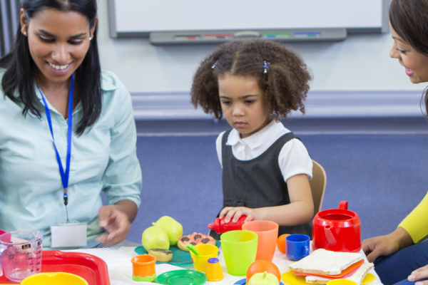 Child care providers with children in a classroom